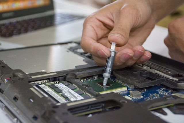 Image of a hand repairing computer in Hillcrest